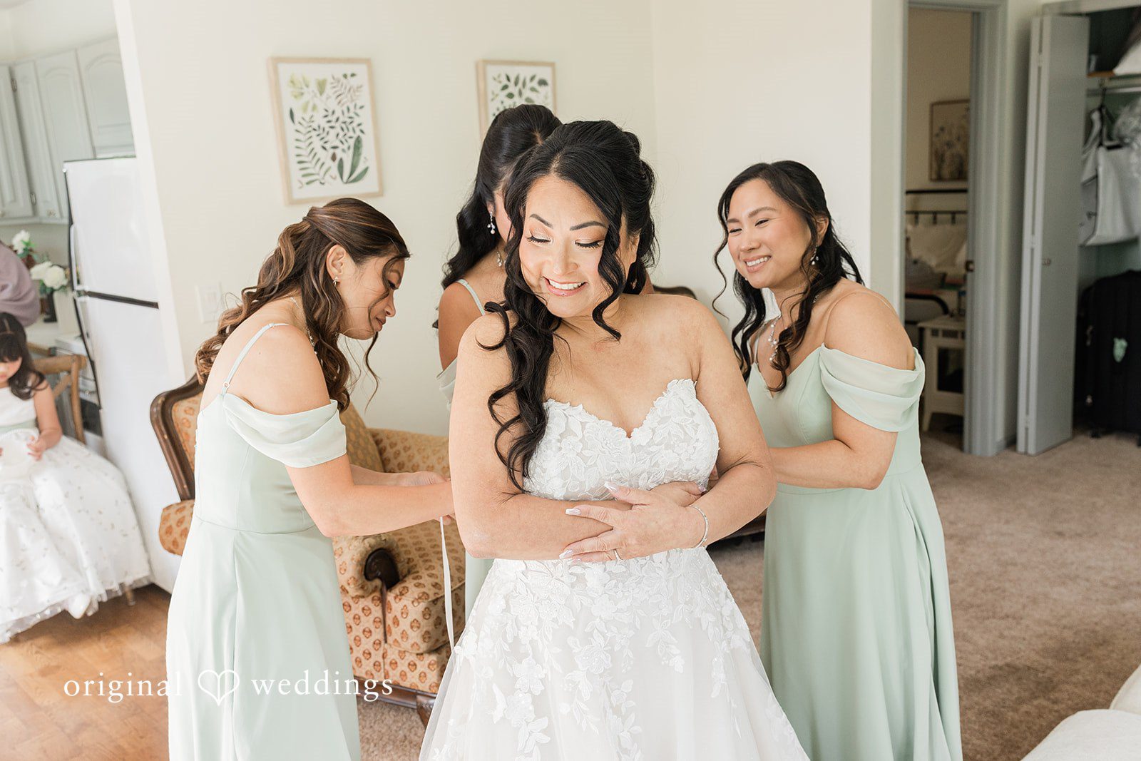 Kim + Keven A group of women helping a bride get ready.