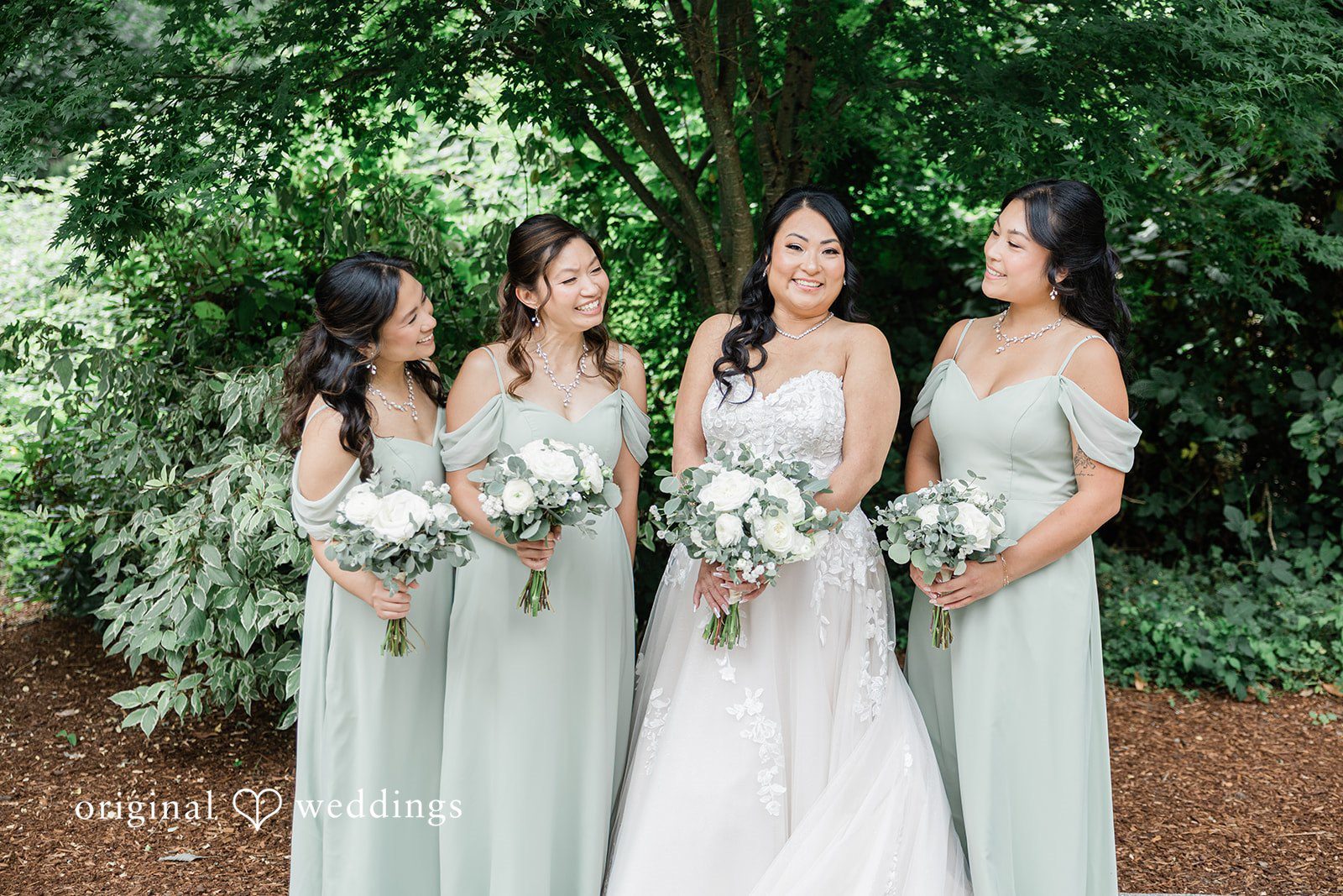 Kim + Keven A bride standing with her bridesmaids in matching dresses.