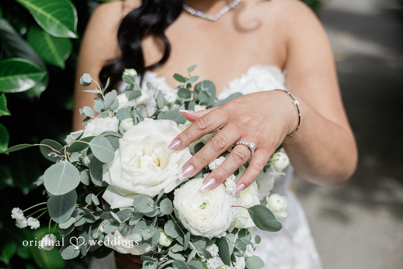Kim + Keven A bride holding a large white floral bouquet.