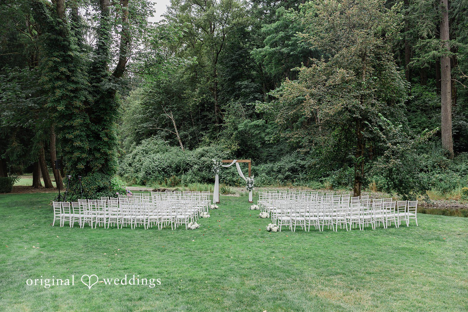 Kim + Keven An empty wedding ceremony setup with rows of chairs.