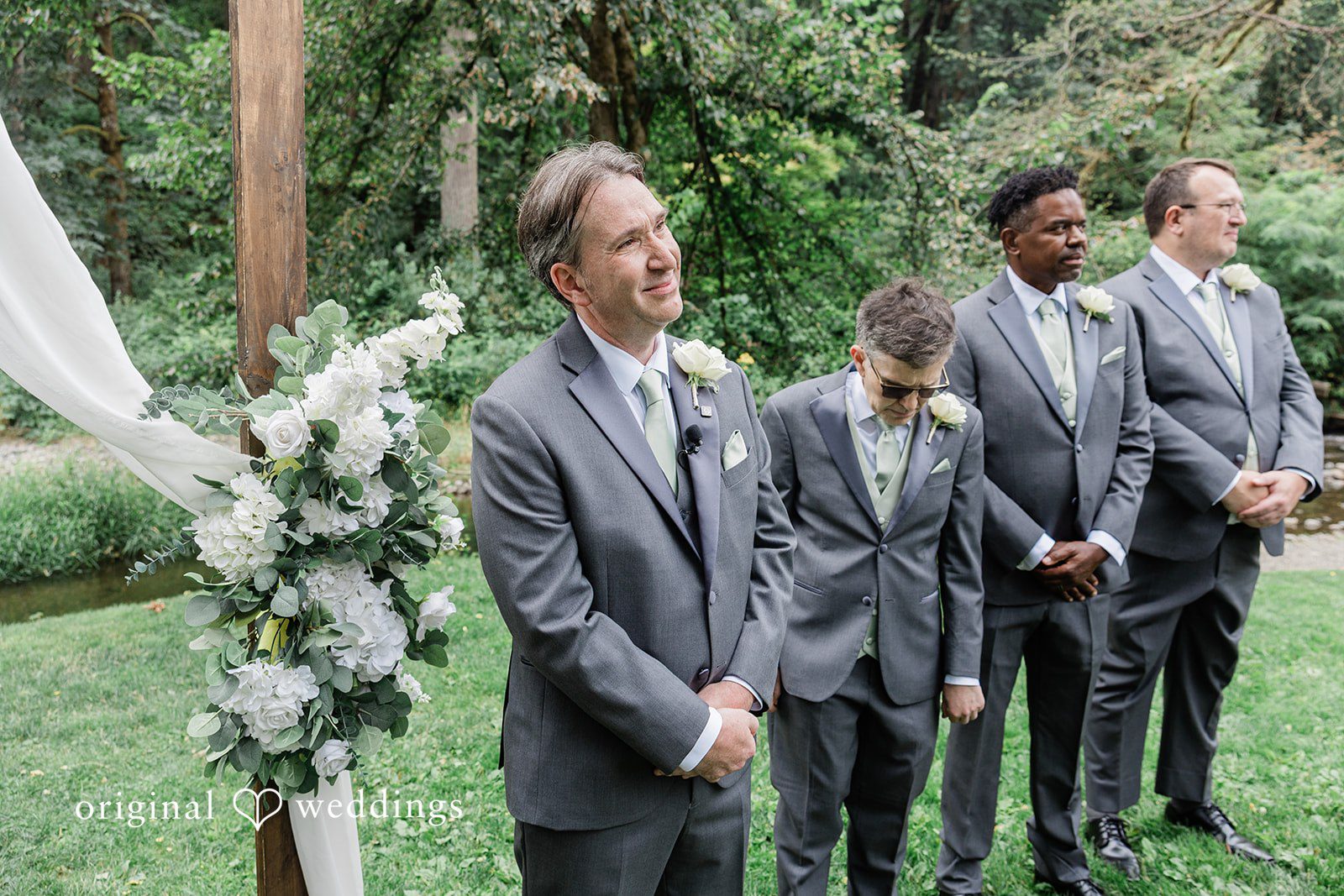 Kim + Keven A group of groomsmen posing together outside.