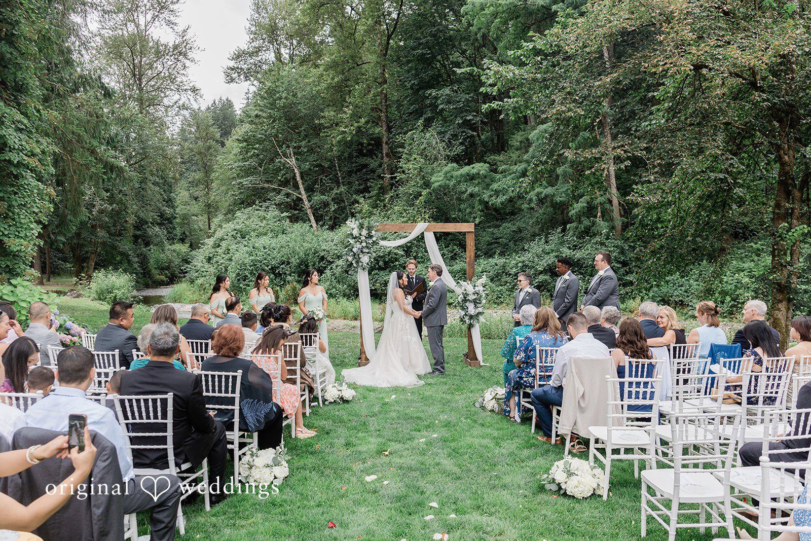 Kim + Keven A wedding ceremony with guests seated.