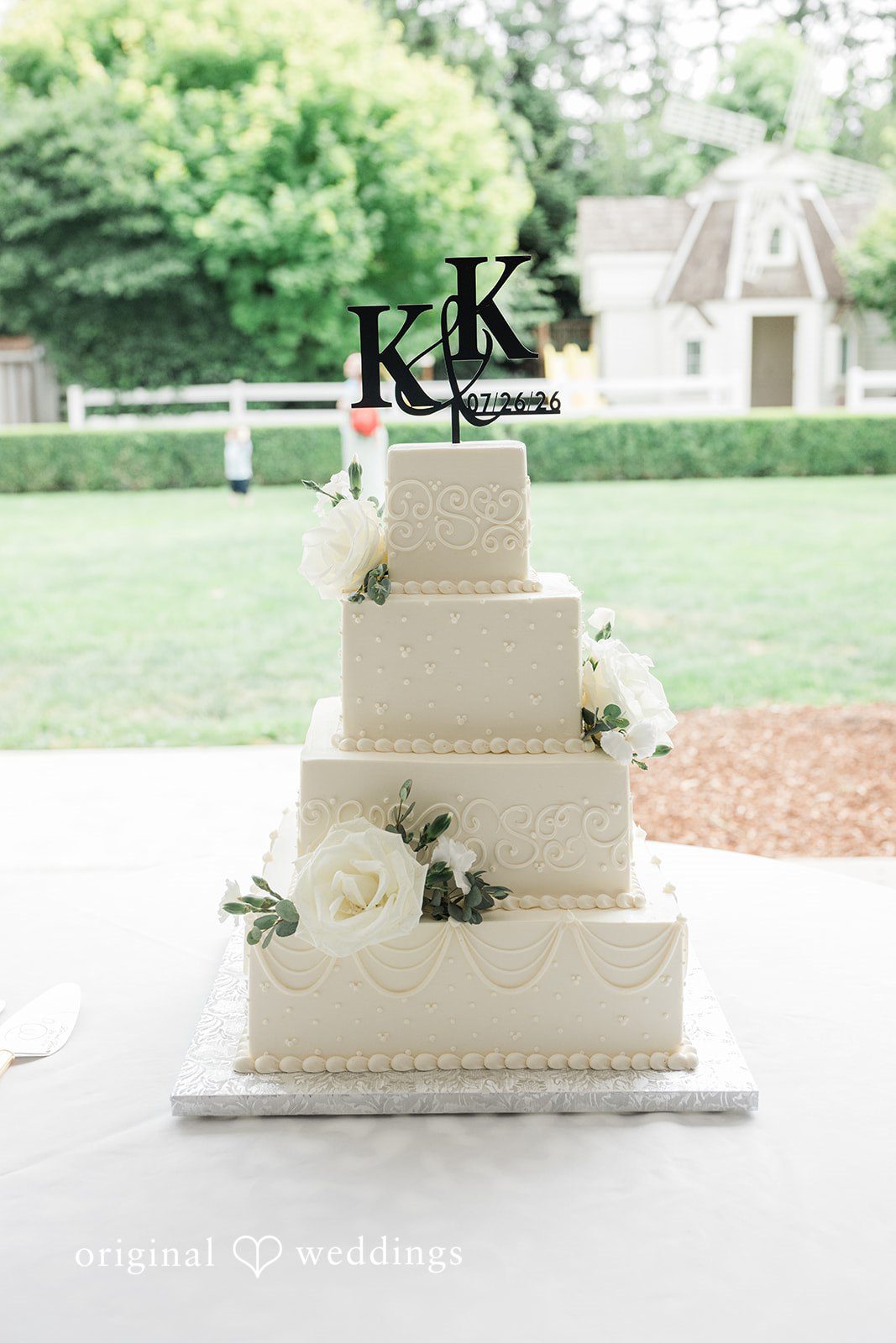 Kim + Keven A square, multi-tiered white wedding cake.