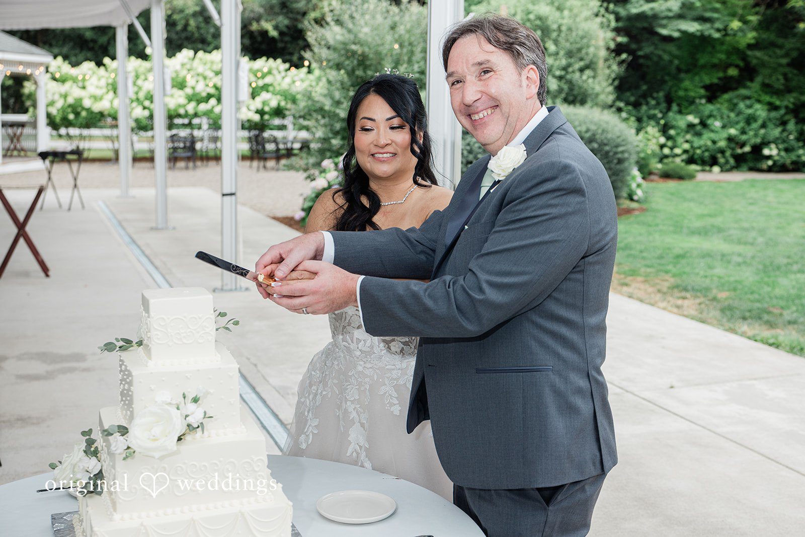 Kim + Keven A bride and groom cutting a wedding cake together.