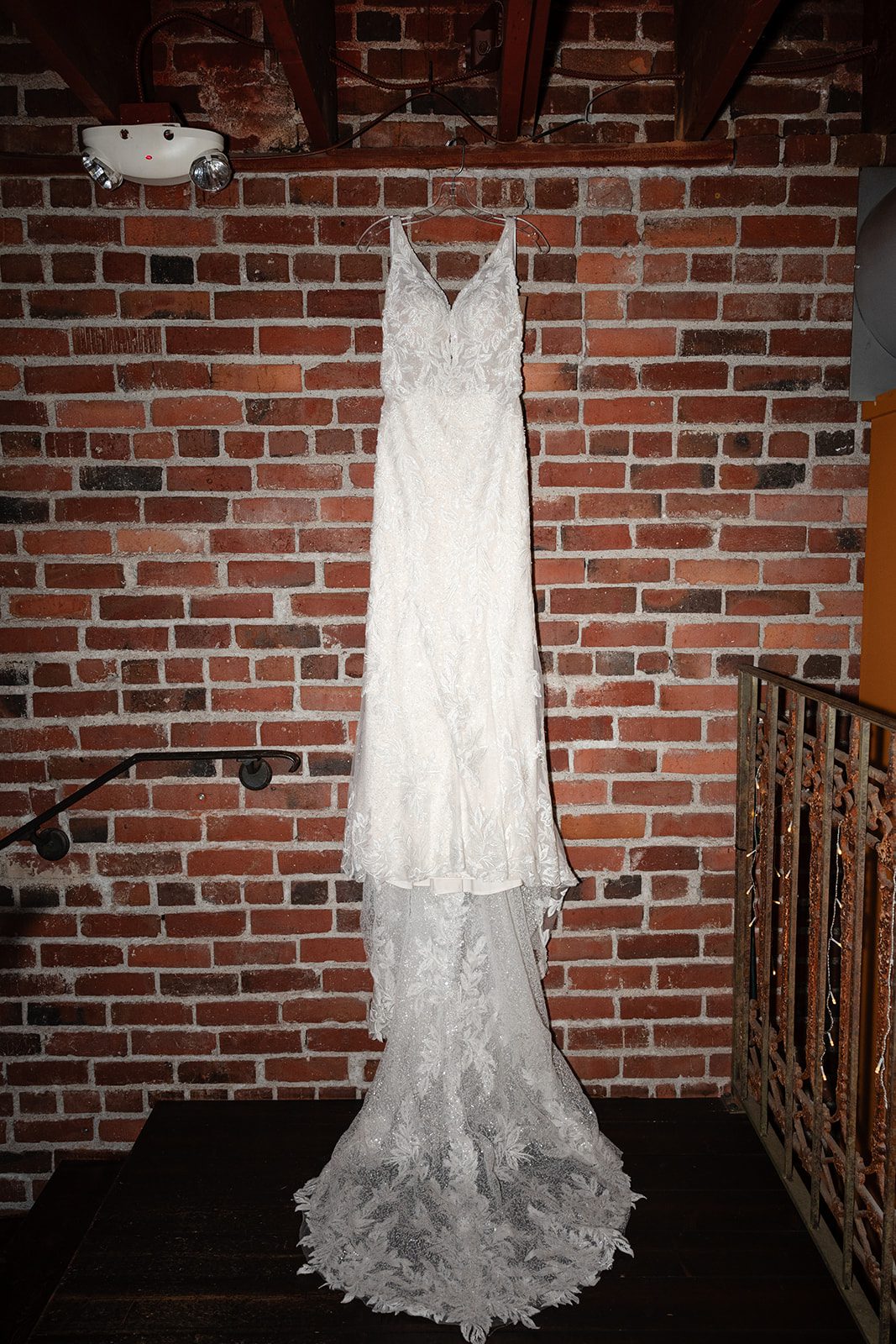 Wedding dress hanging on the brick wall at Georgetown Ballroom Wedding dress hanging on the brick wall at Georgetown Ballroom