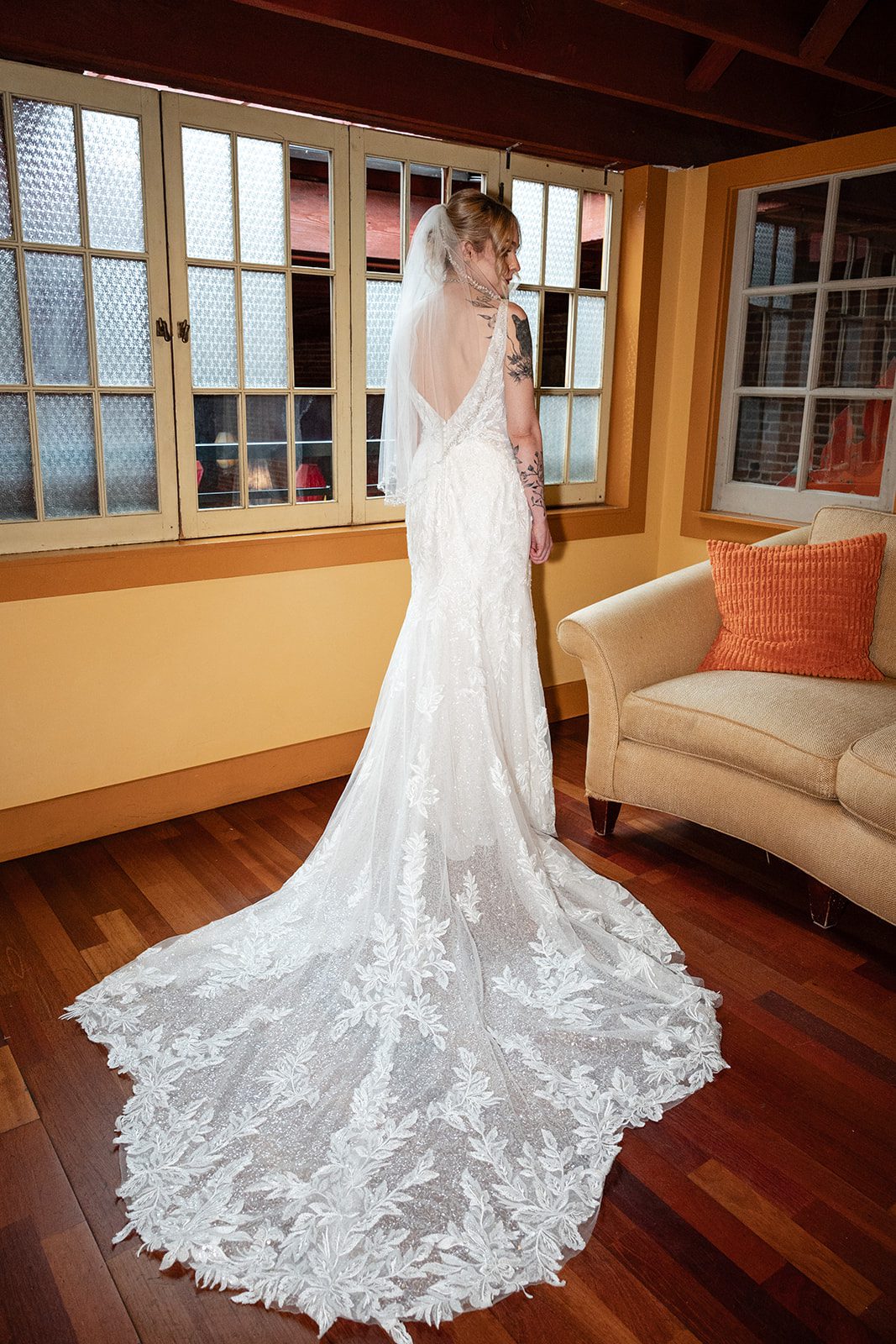 Bride in her lace gown by the window Bride in her lace gown by the window