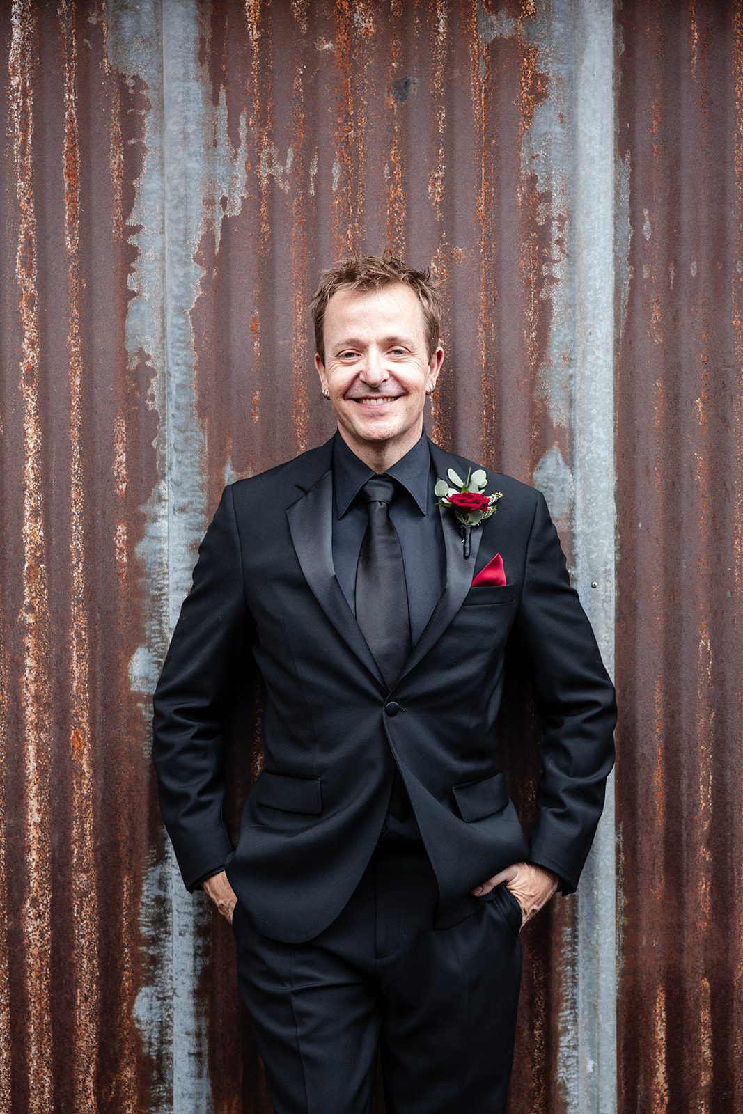 Groom smiling in his black suit Groom smiling in his black suit