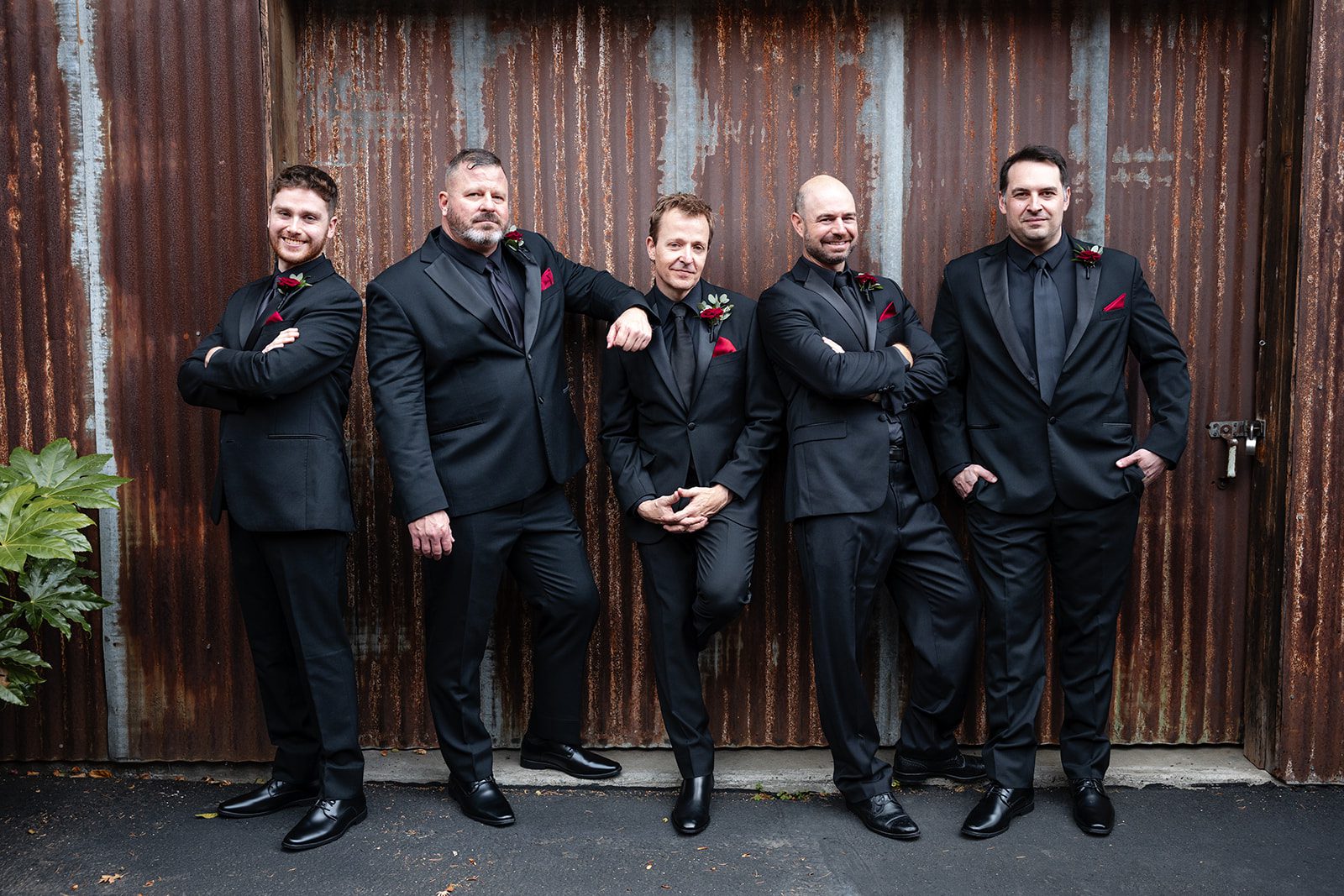Groomsmen in front of the wooden doors Groomsmen in front of the wooden doors