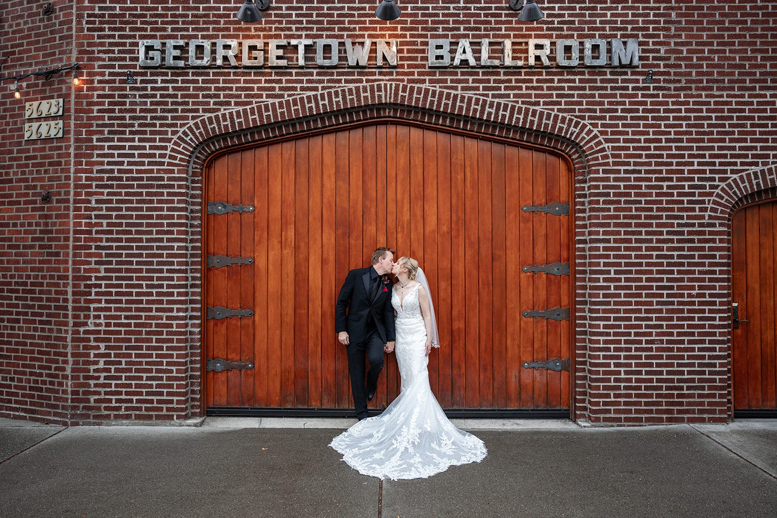 Couple kissing at the doors of Georgetown Ballroom Couple kissing at the doors of Georgetown Ballroom