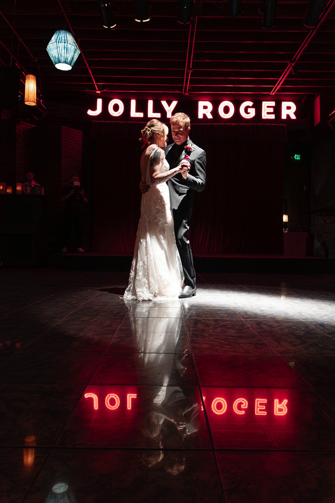 Couple dancing under the colored lights Couple dancing under the colored lights