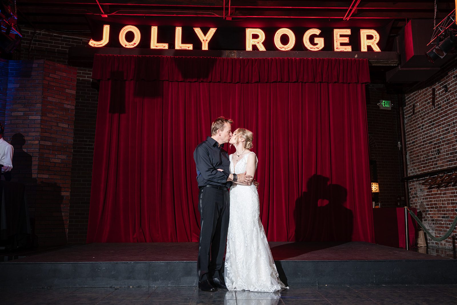 Couple dancing under the Jolly Roger sign Couple dancing under the Jolly Roger sign