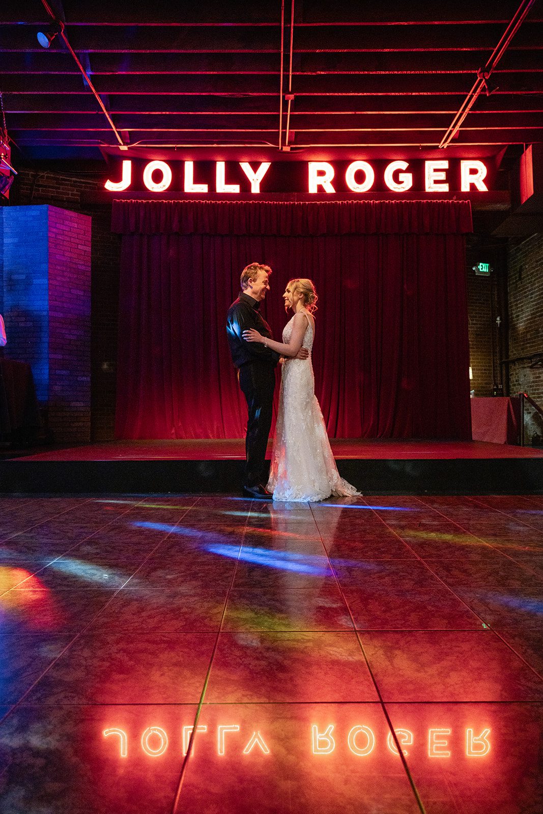 First dance with stage lights, captured by Seattle wedding photographers First dance with stage lights, captured by Seattle wedding photographers