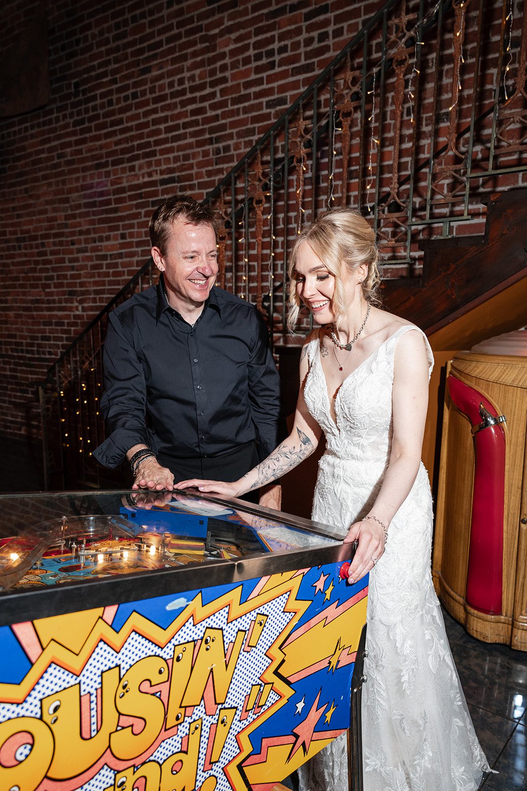 Couple playing an arcade game Couple playing an arcade game
