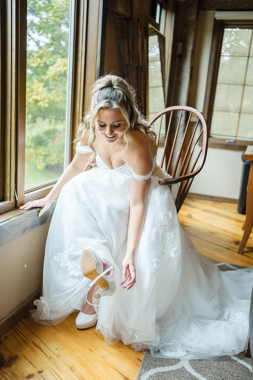 Bride sitting by the window at Glasbern