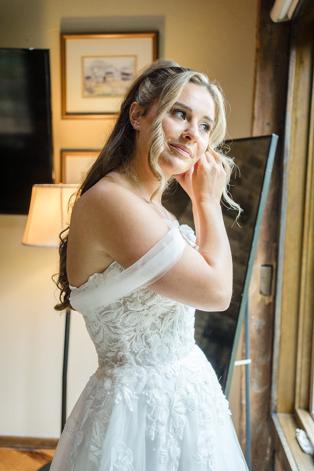 Bride getting ready in soft window light