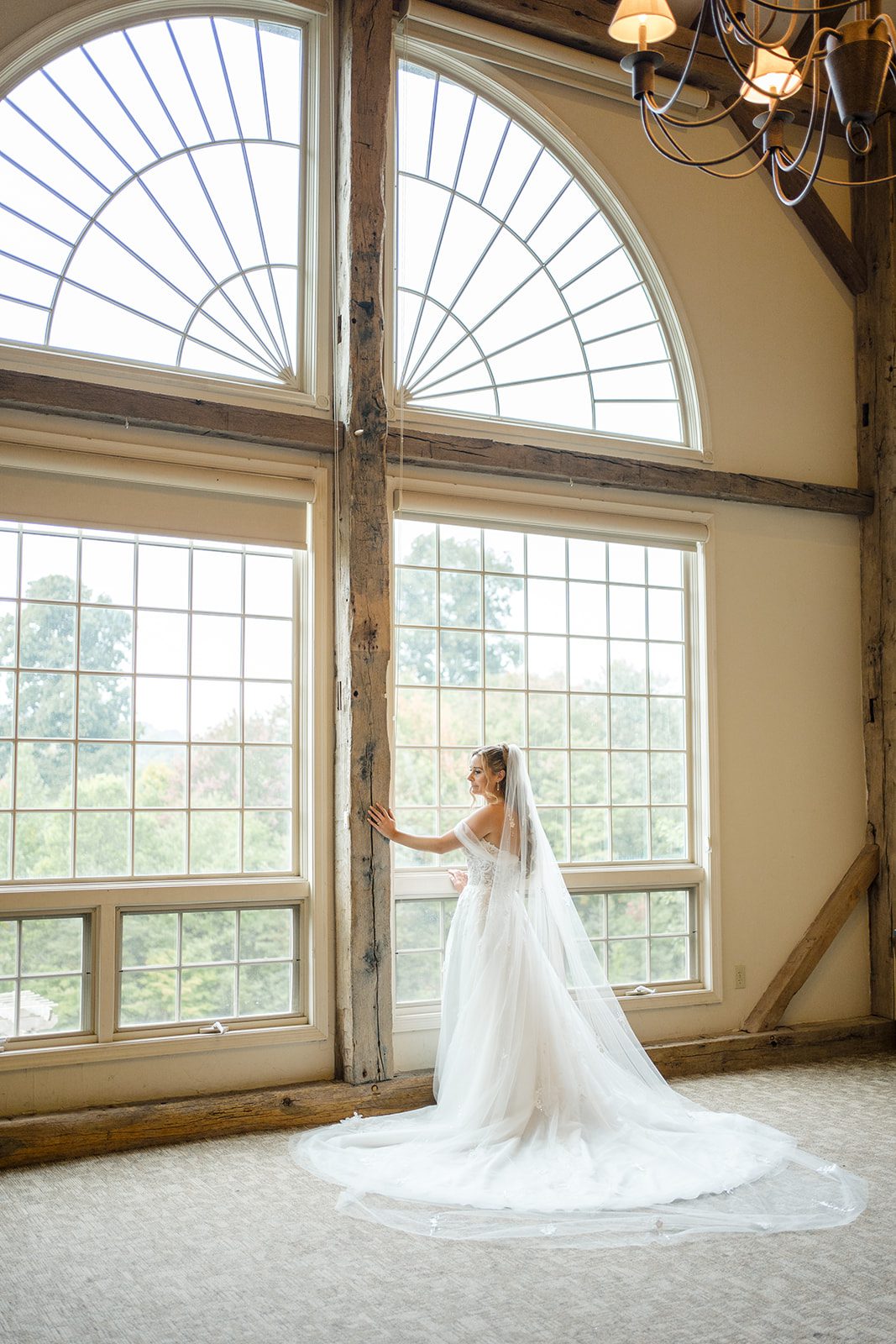 Bride in front of the arched windows at Glasbern