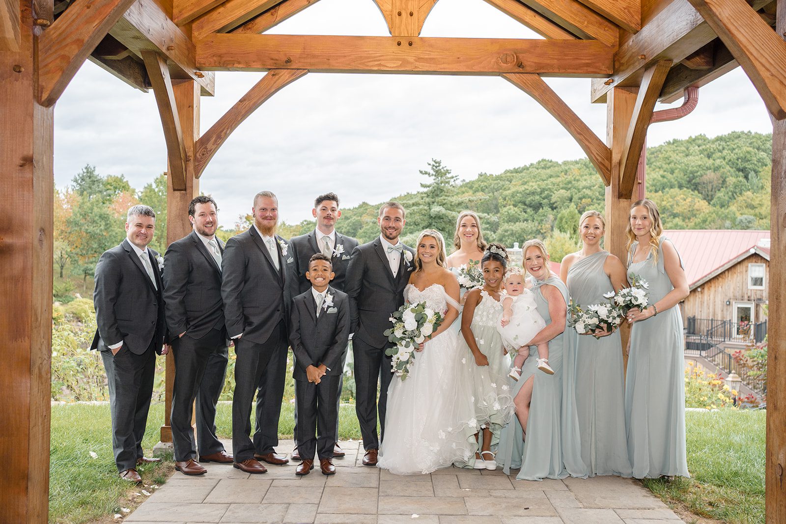 Wedding party lined up under the timber pavilion at Glasbern