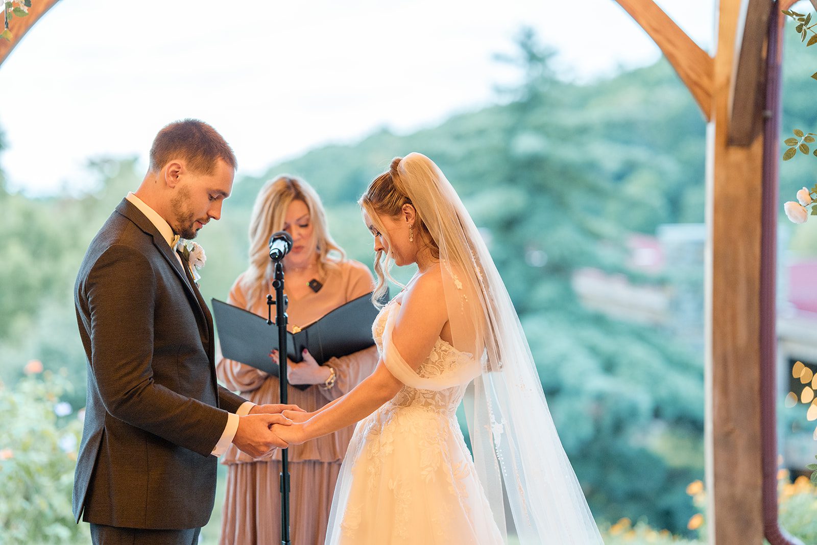 Bride and groom holding hands during the vows