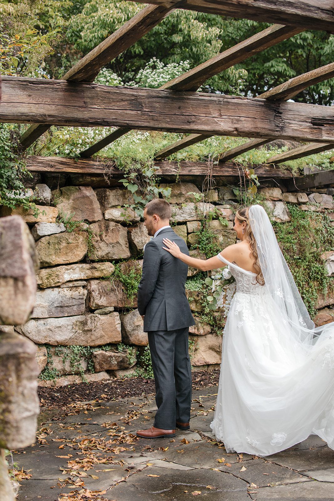 Groom waiting by the stone wall