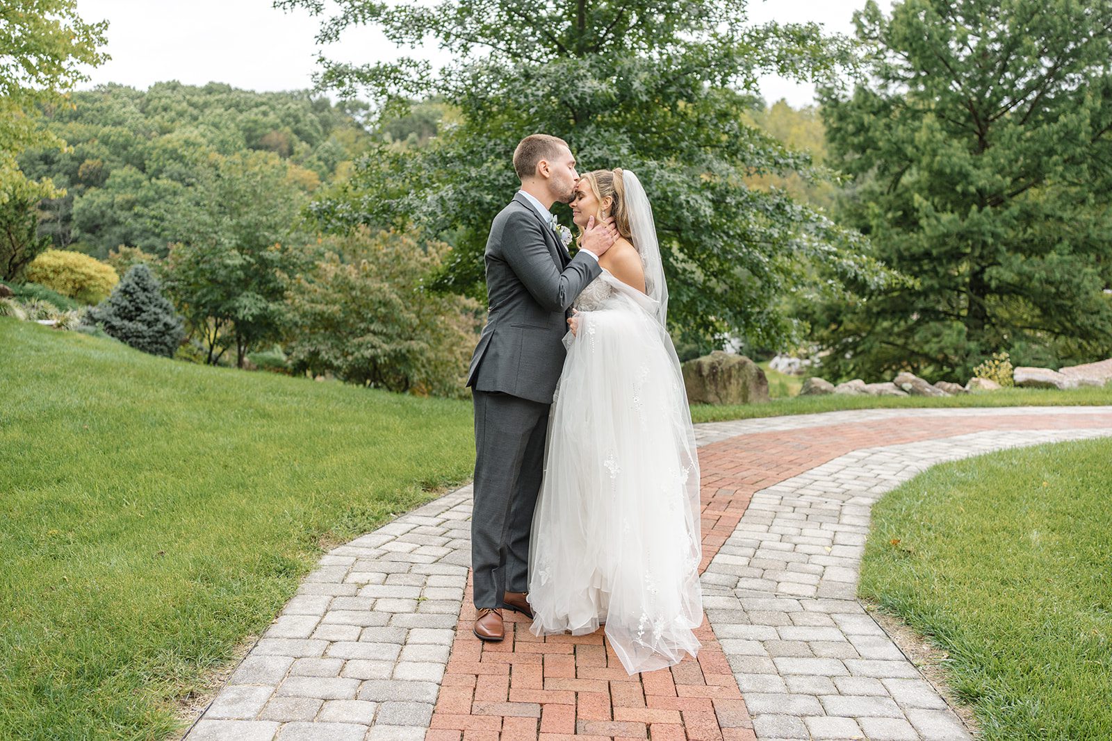 Couple kissing on the garden path