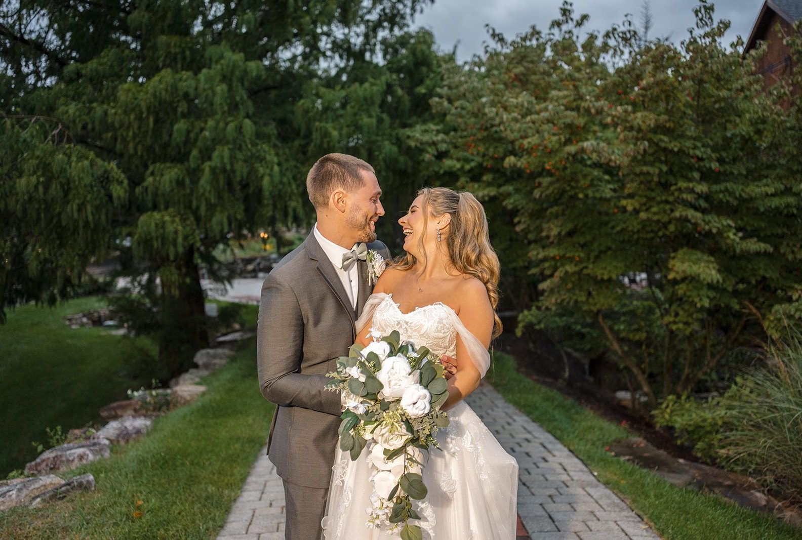 Bride and groom smiling together outdoors, captured by Philadelphia wedding photographers from Original Weddings at Glasbern