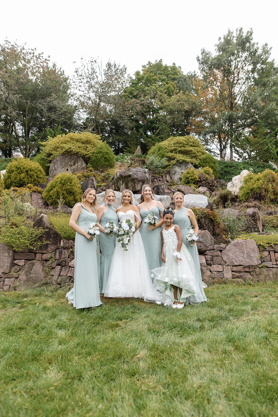 Bride with her bridesmaids in sage green
