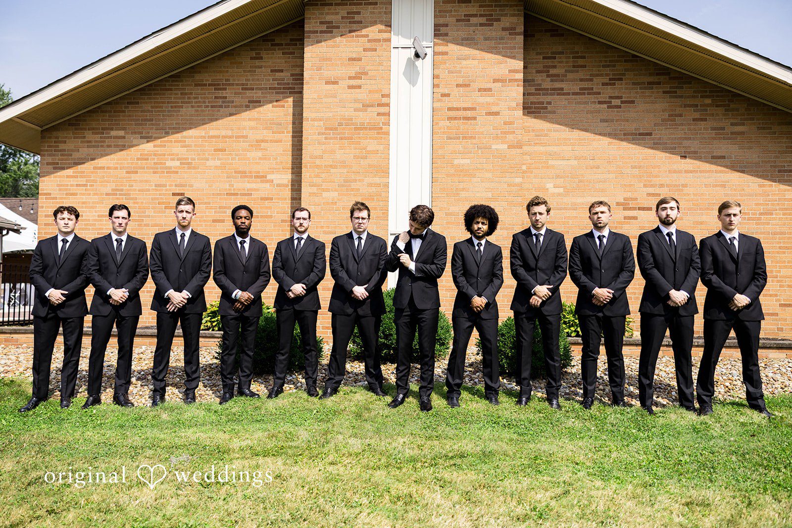 Ethan + Kelcy Groom and groomsmen in front of the church at Grace Church Barberton