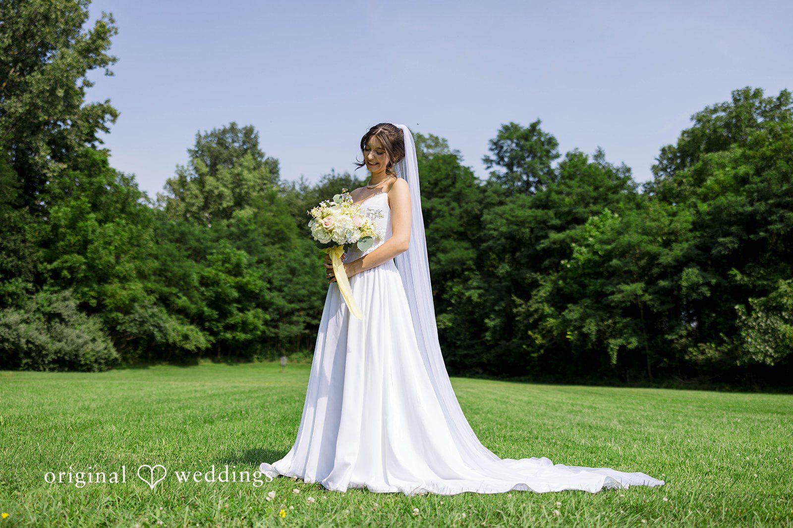 Ethan + Kelcy Bride standing alone on the lawn