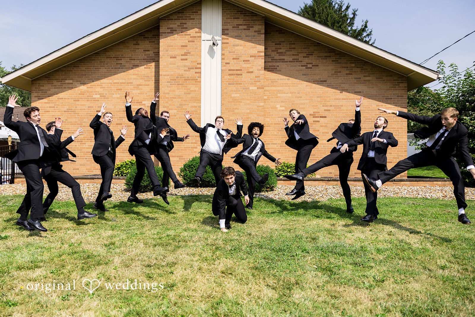 Ethan + Kelcy Groomsmen jumping outside the church