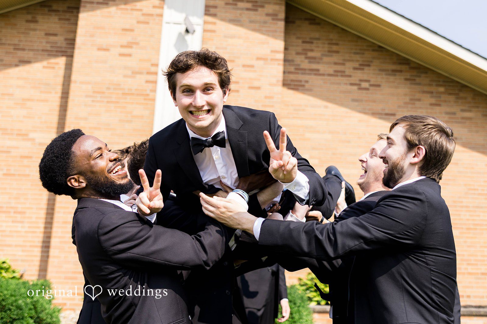 Ethan + Kelcy Groomsmen lifting the groom