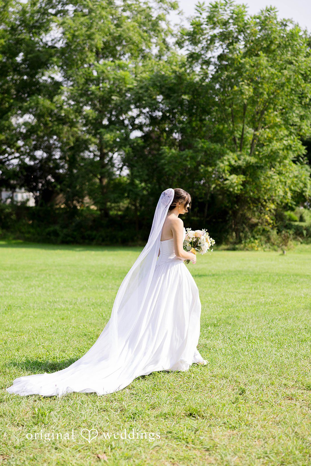 Ethan + Kelcy Bride posing on the grass
