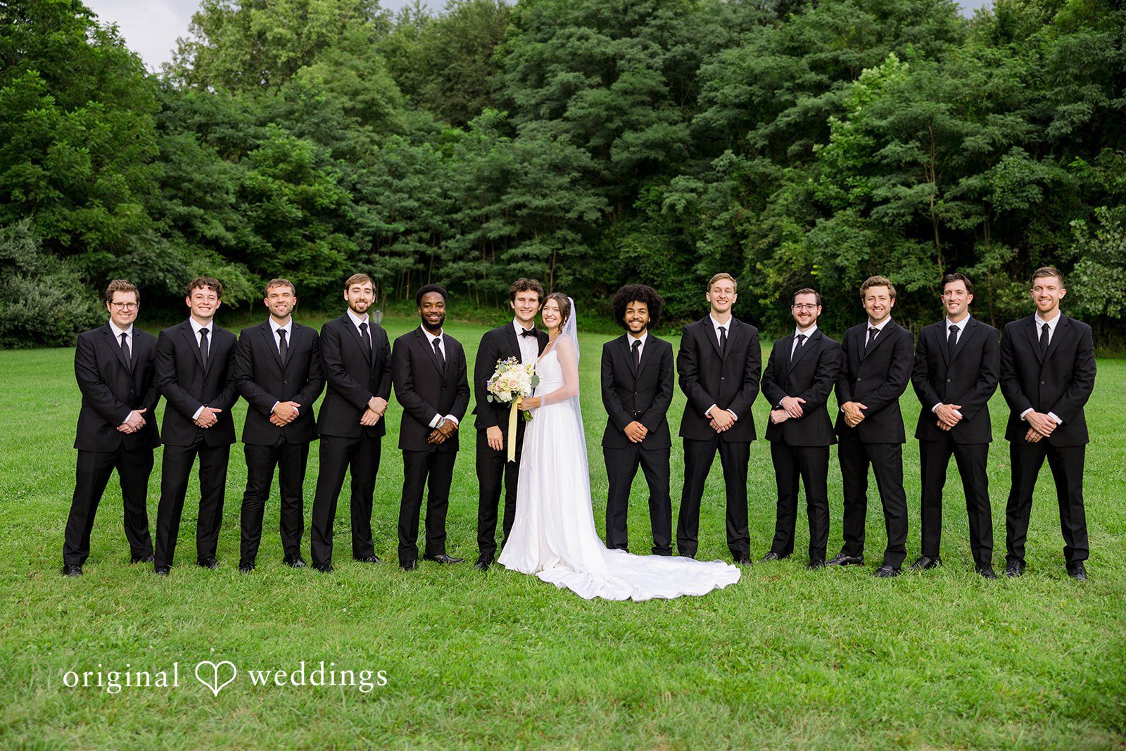 Ethan + Kelcy Wedding party lined up on the grass