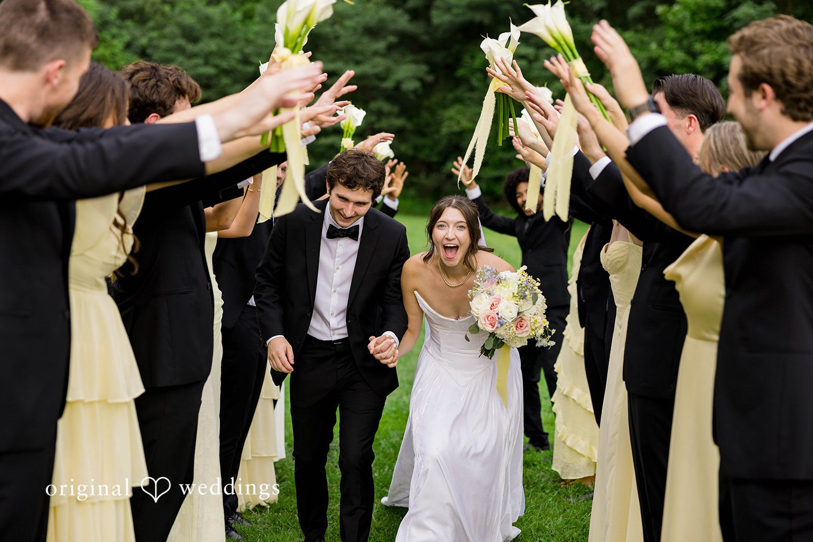 Ethan + Kelcy Wedding party throwing their hands up