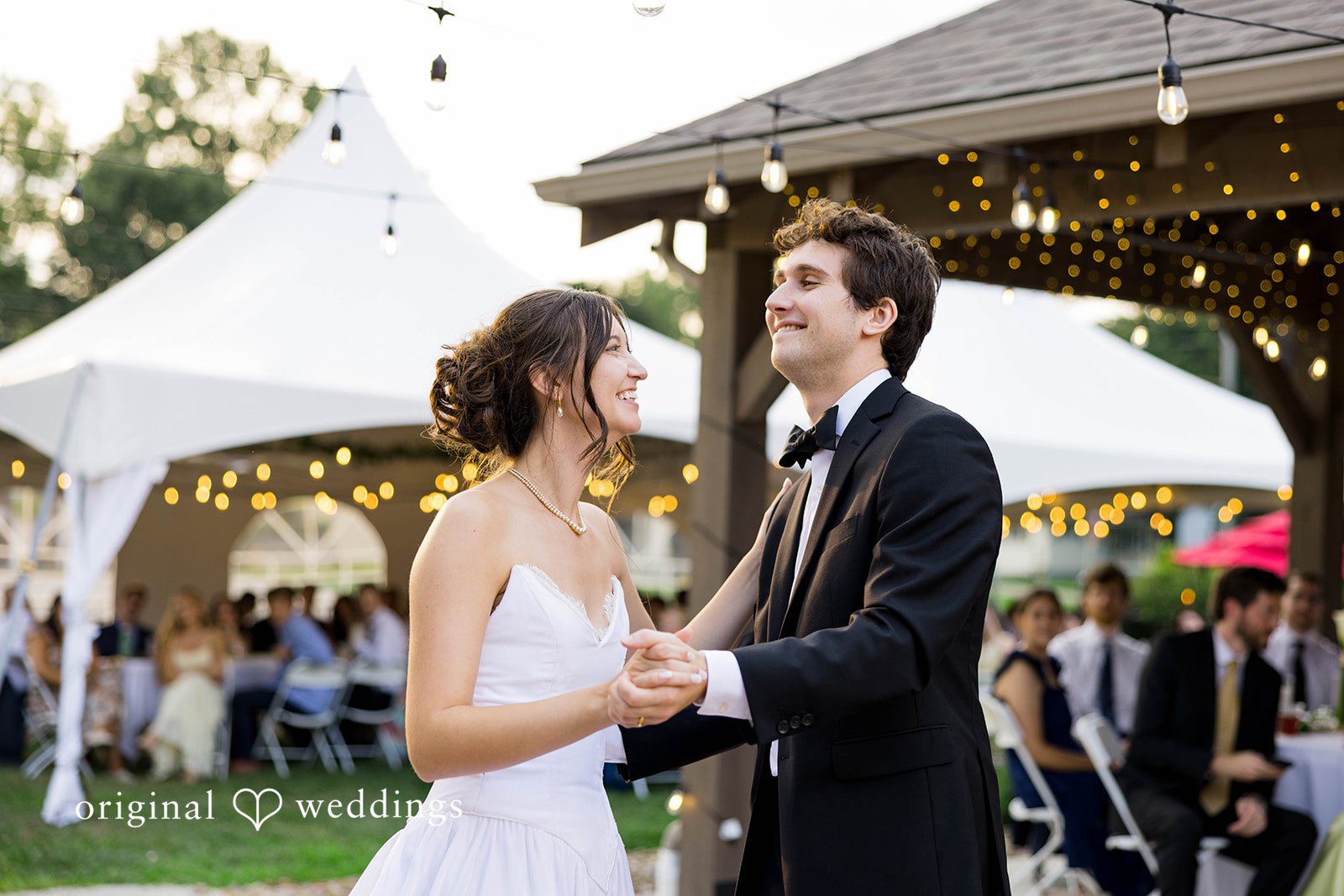 Ethan + Kelcy Couple greeting guests under the reception tent