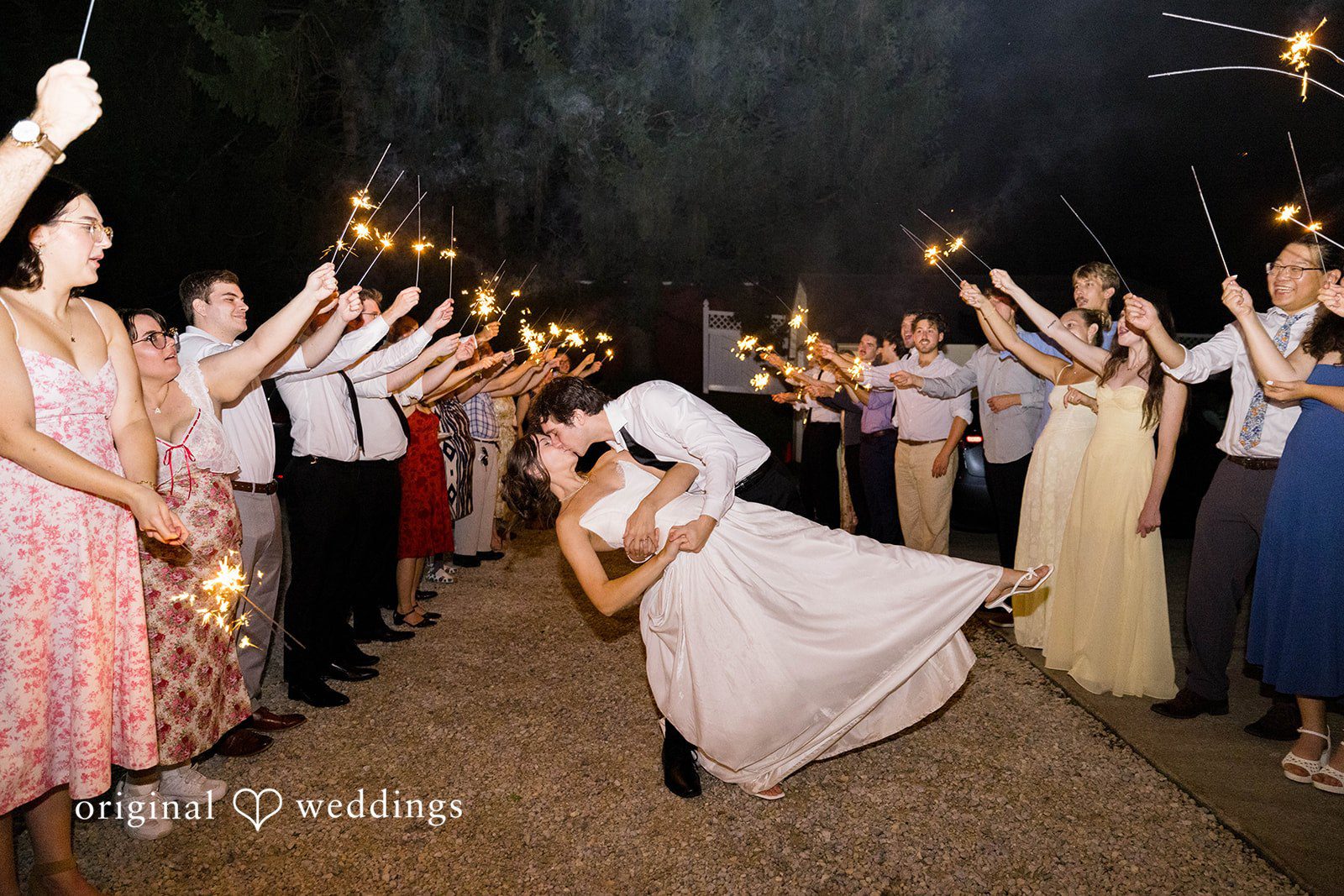 Ethan + Kelcy Couple dipping for a kiss under sparklers