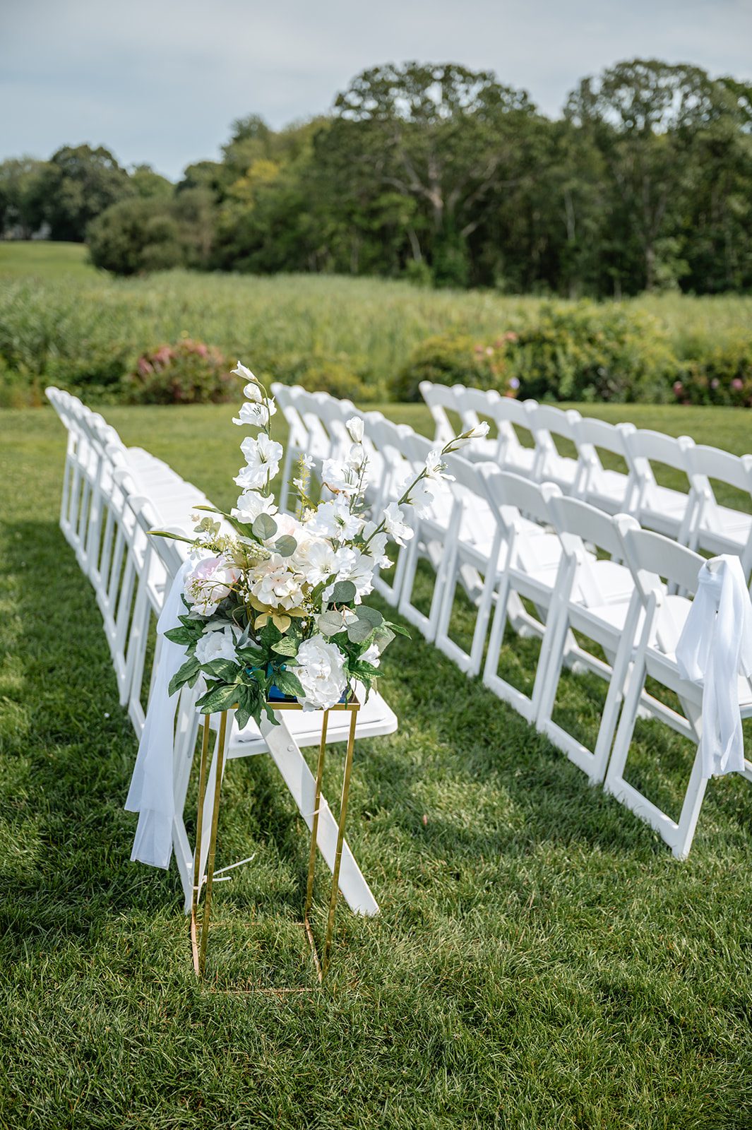 harbor-lights-timeless-providence-feng-donald-p002-36 Rows of white ceremony chairs on the lawn at Harbor Lights