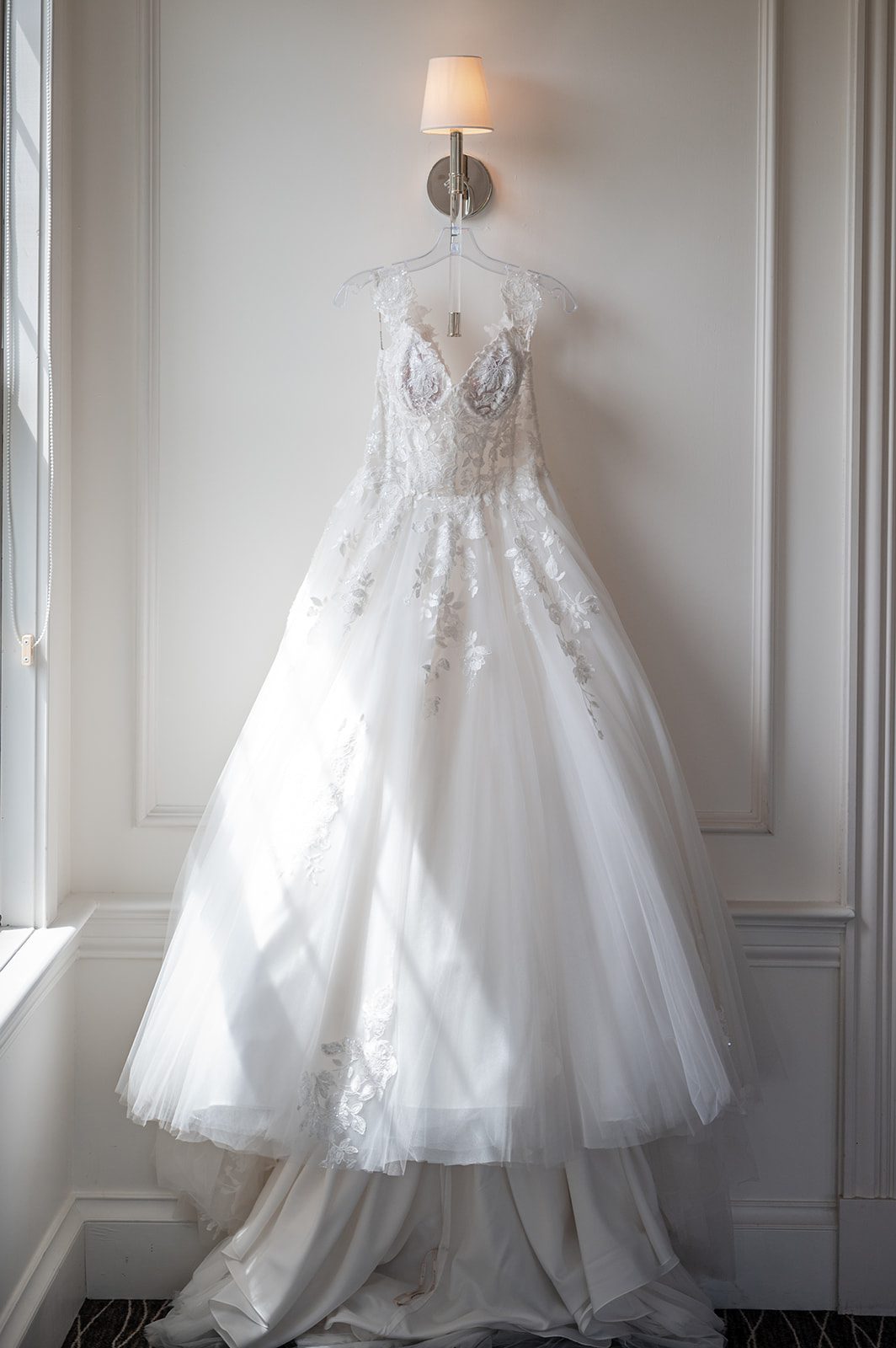 harbor-lights-timeless-providence-feng-donald-p008-14 Wedding gown hanging by the window