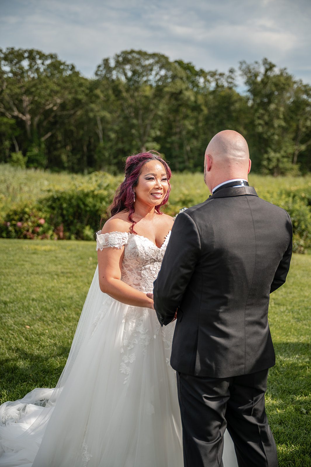 harbor-lights-timeless-providence-feng-donald-p020-45 Bride and groom facing each other during the ceremony