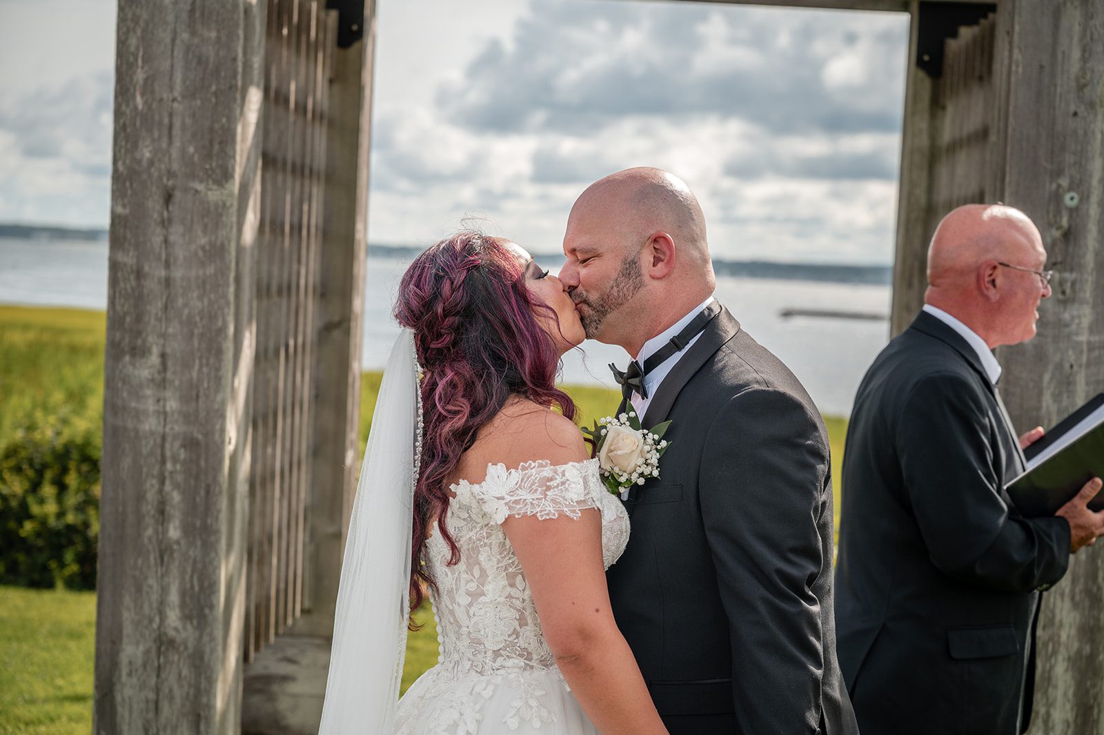 harbor-lights-timeless-providence-feng-donald-p024-12 Couple exchanging vows beneath the wooden arbor