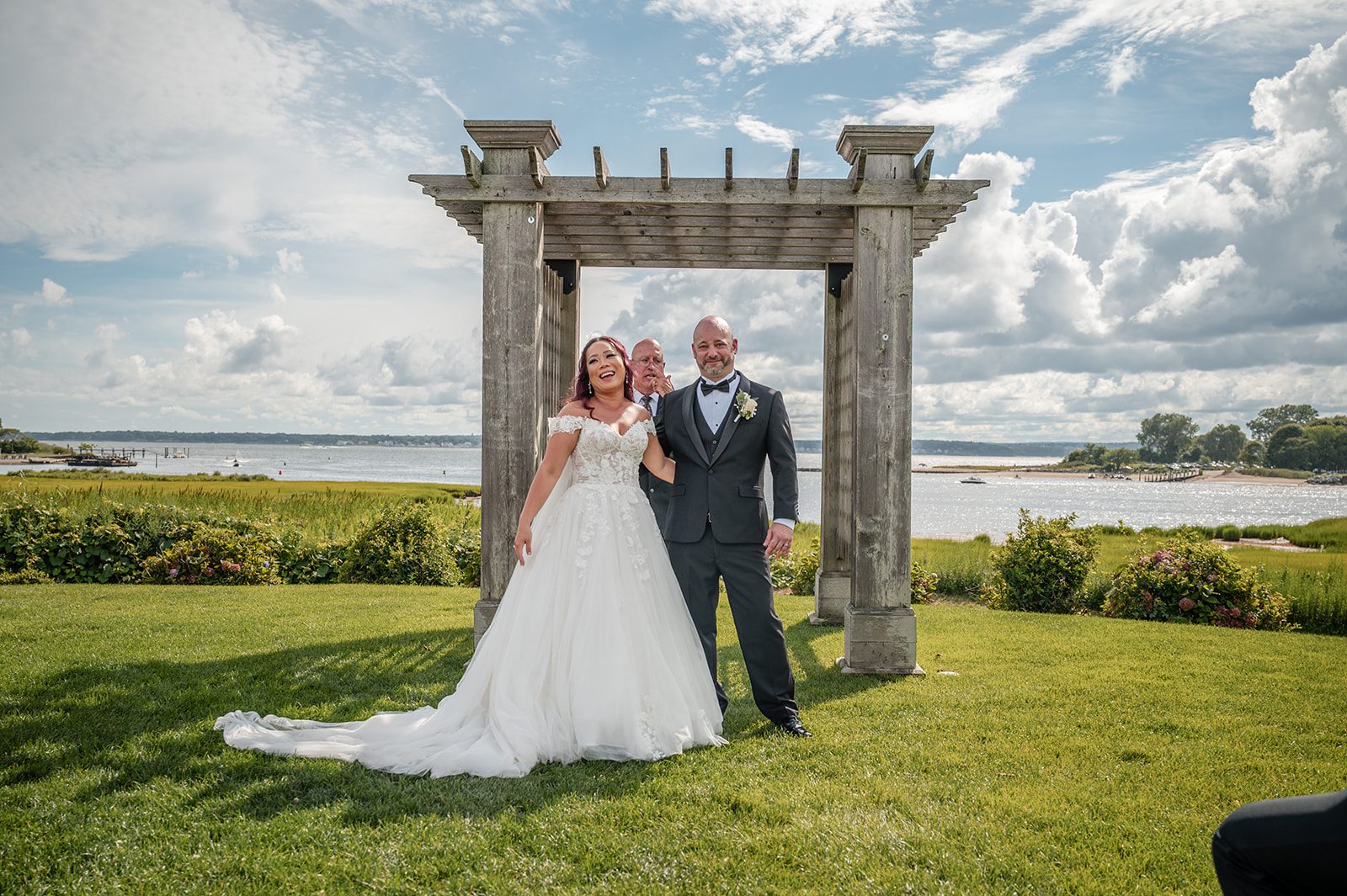 harbor-lights-timeless-providence-feng-donald-p025-23 Bride and groom at the ceremony arbor by the water at Harbor Lights