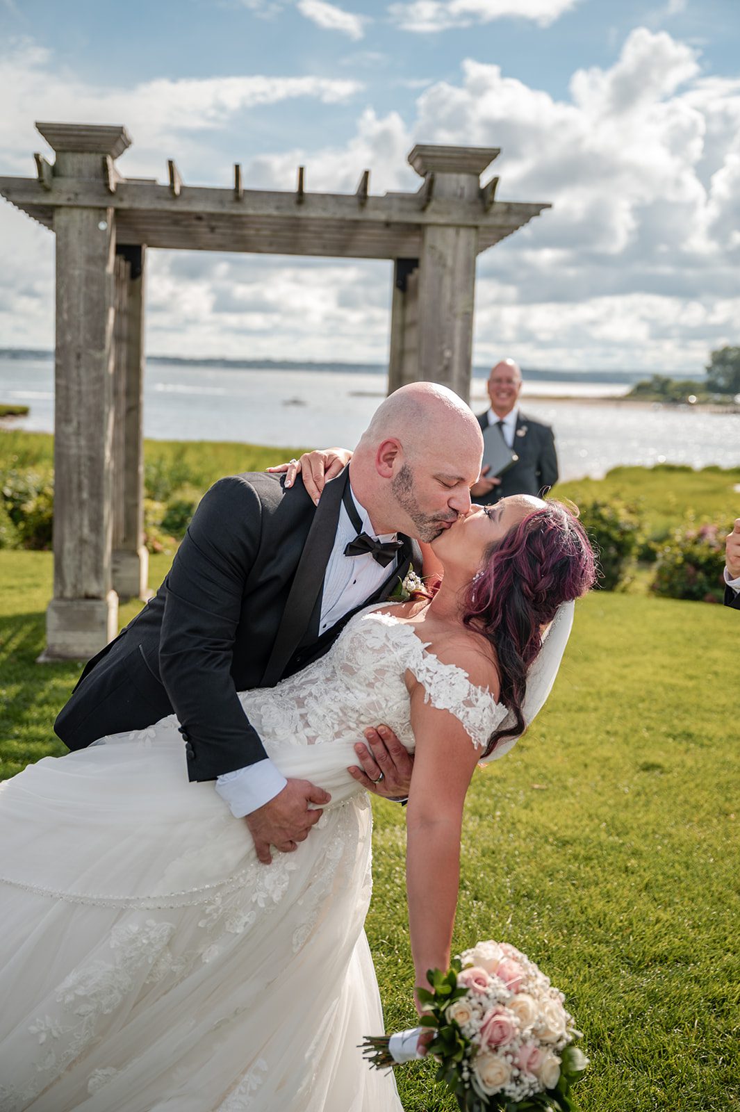 harbor-lights-timeless-providence-feng-donald-p029-47 Groom dipping the bride for a kiss at the arbor
