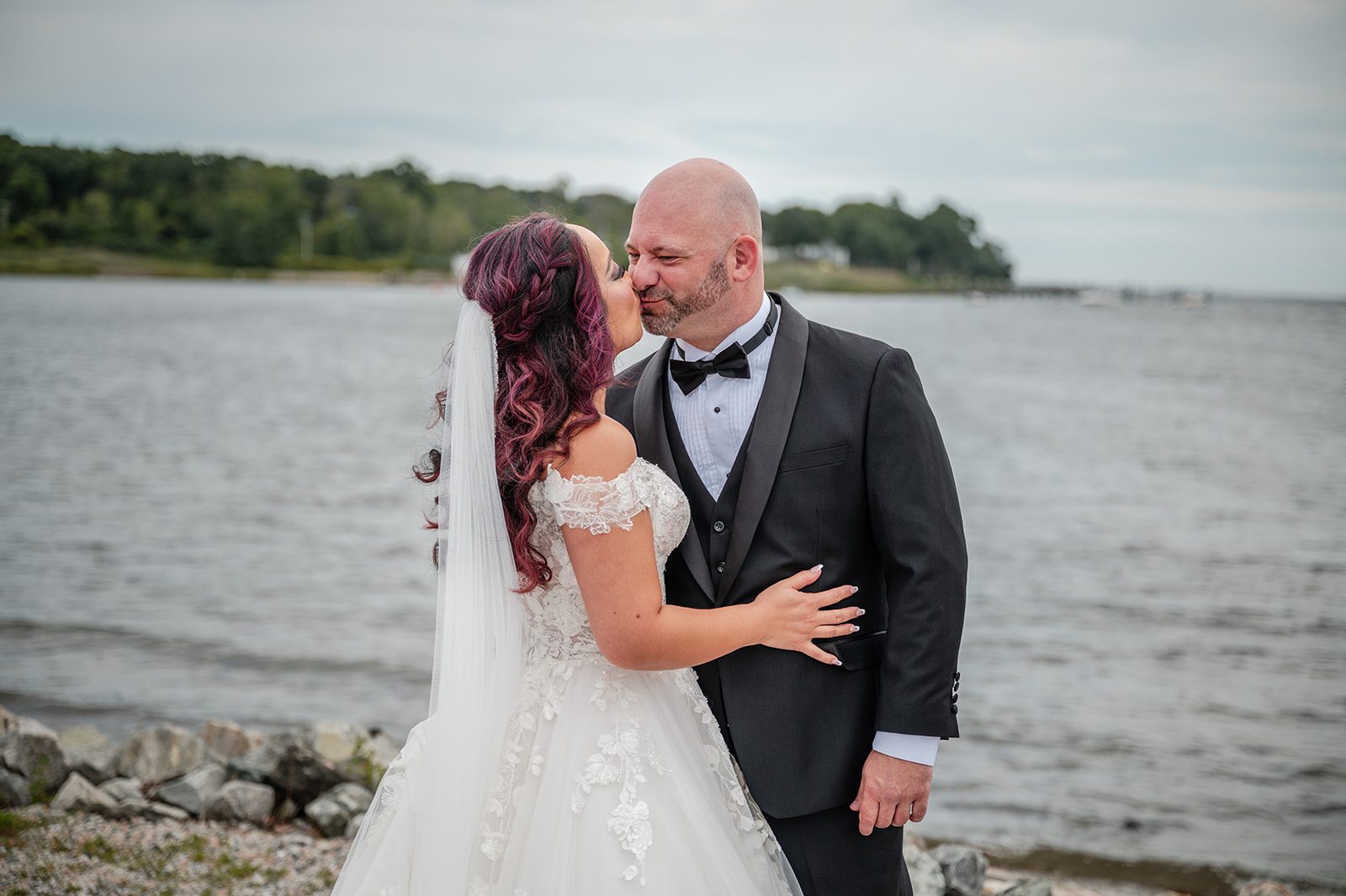 harbor-lights-timeless-providence-feng-donald-p034-18 Bride and groom sharing a kiss by the bay