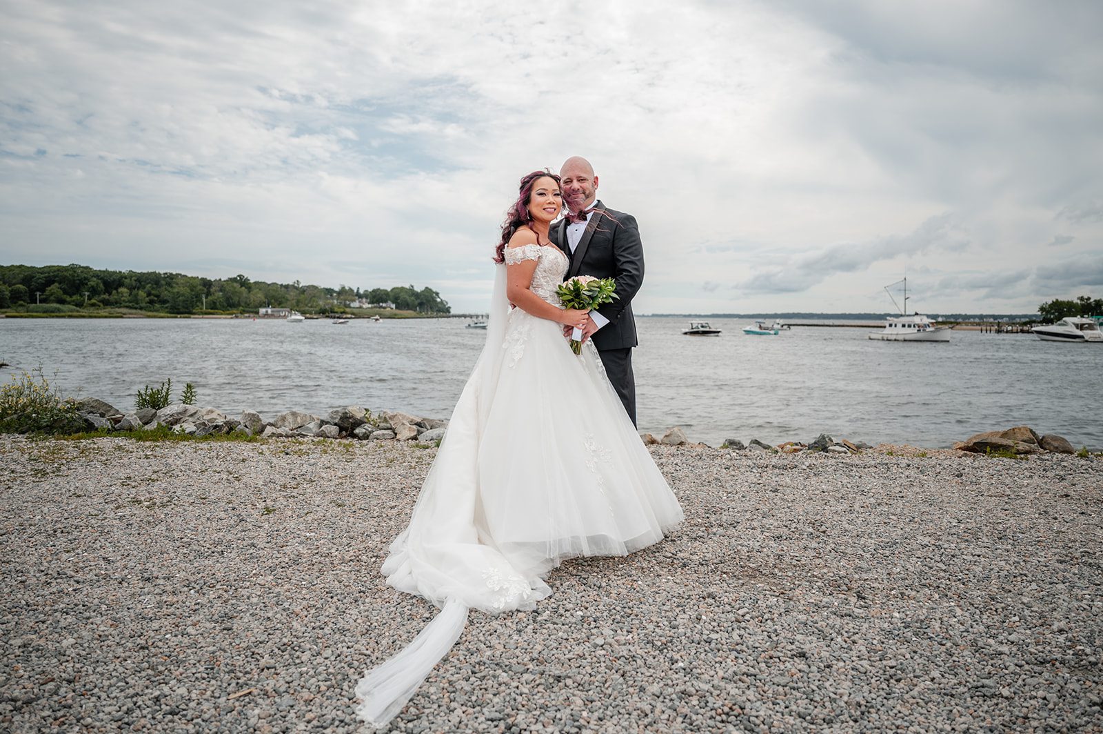 harbor-lights-timeless-providence-feng-donald-p037-37 Groom spinning the bride along the shoreline