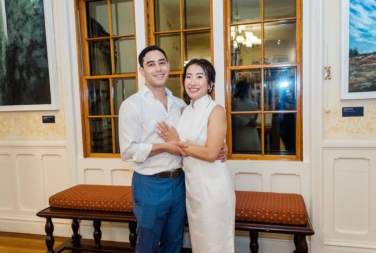Athena and James smiling together by the tall windows, captured by Providence wedding photographers from Original Weddings at Highfield Hall and Gardens