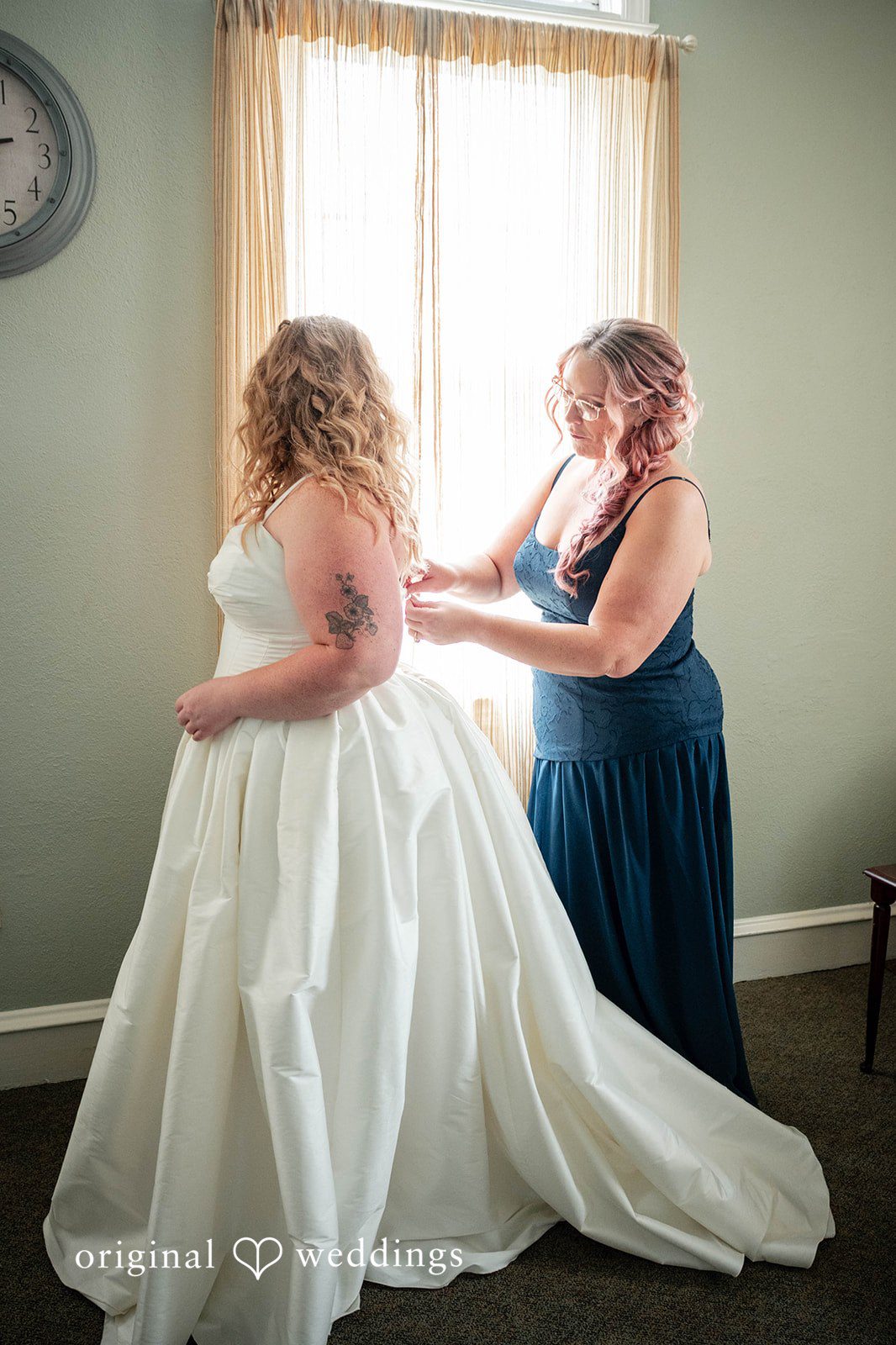 Bethany + Eddie Bride getting help with her gown