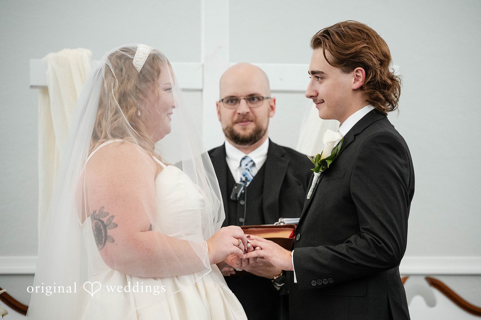 Bethany + Eddie Couple exchanging vows with the pastor