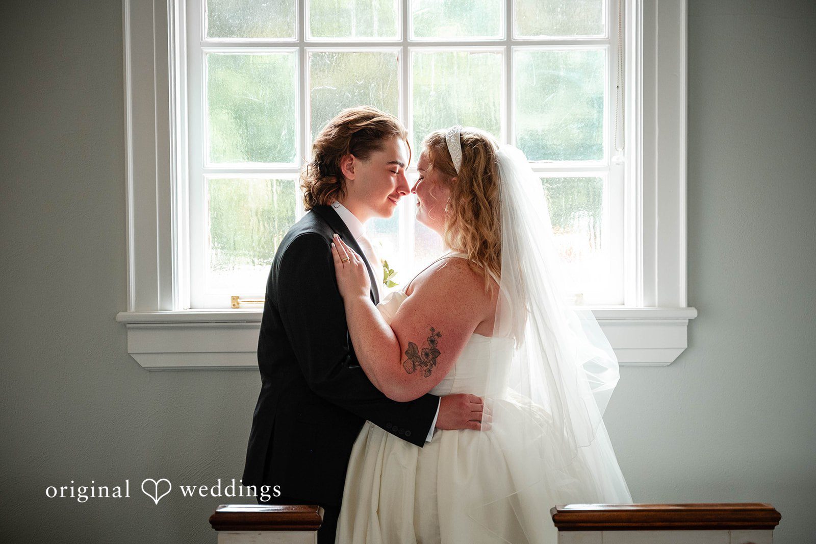 Bethany + Eddie Bride and groom by the church window at Immanuel Orthodox Presbyterian Church