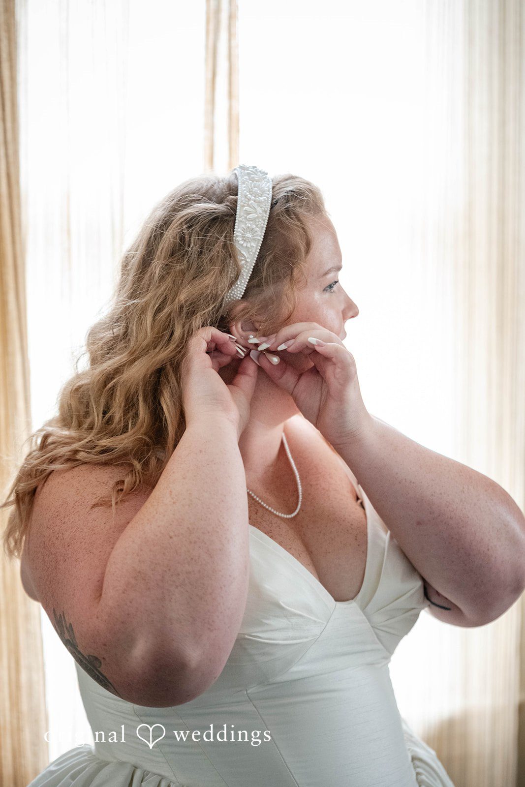 Bethany + Eddie Bride putting on her earrings