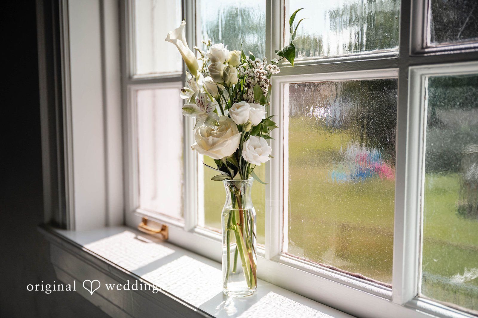 Bethany + Eddie Bride's bouquet resting in the window