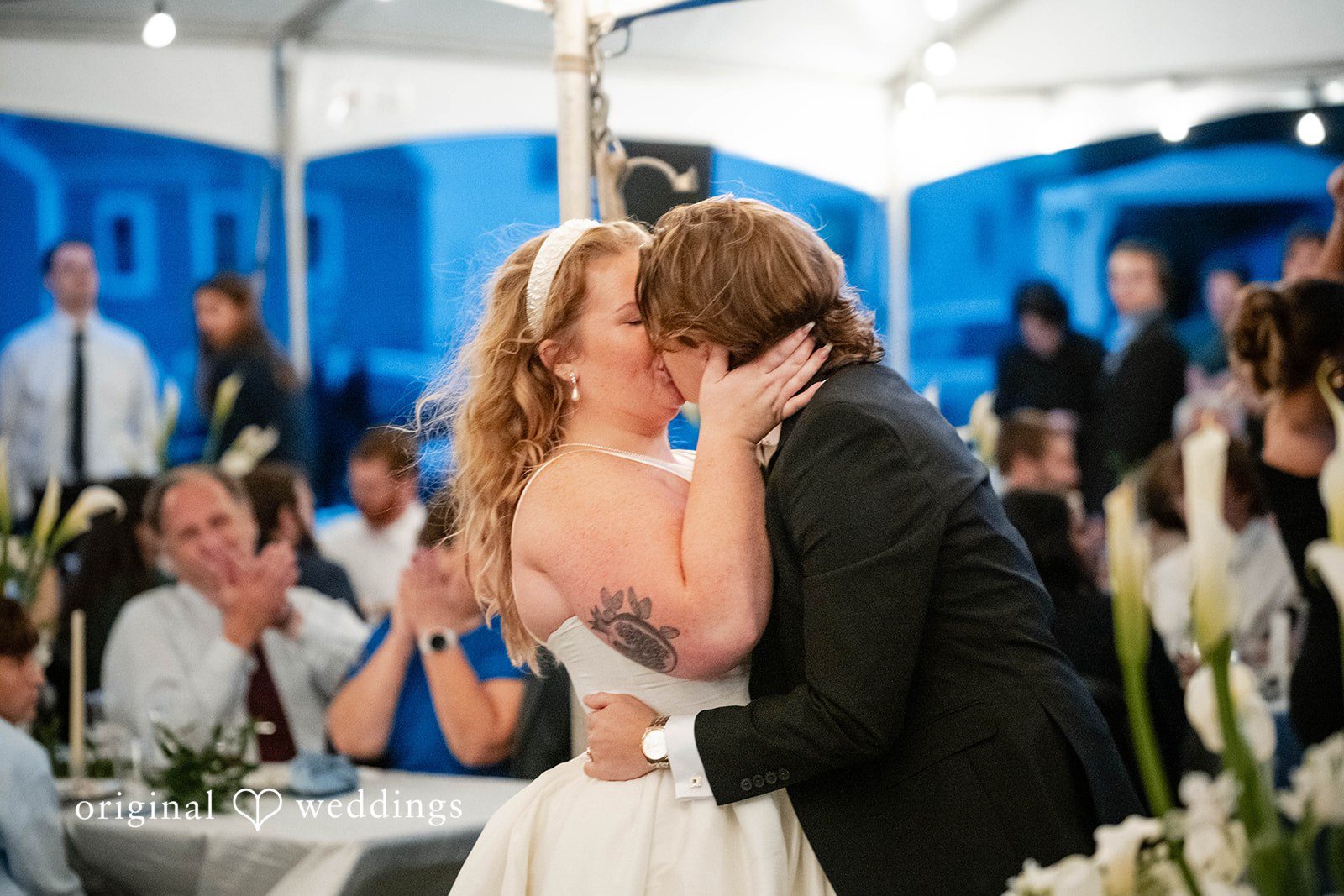 Bethany + Eddie Couple sharing a kiss at the reception